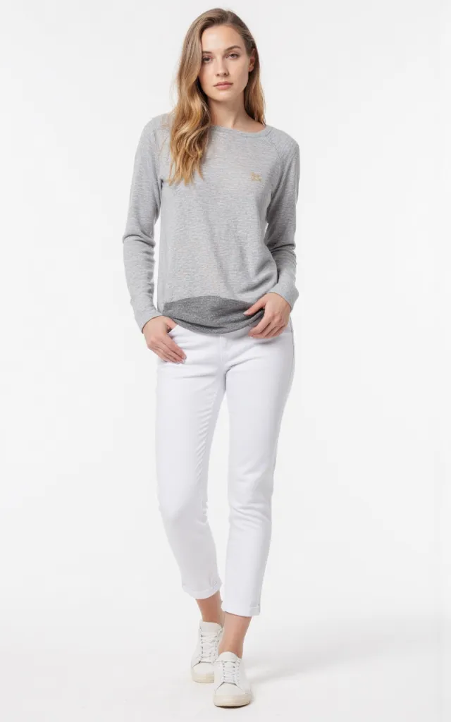 A French female model wearing Casual   style clothing, against a white background, in a front   facing shot focusing on shoes